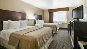 A hotel room with two beds, a television, and a desk. - Best Western San Marcos (San Marcos)