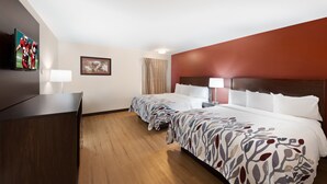 A hotel room with two beds, a TV, a desk, and a painting on the wall. - Red Roof Inn El Paso West (El Paso)