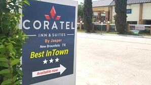 A hotel sign for Coratel Inn & Suites in New Braunfels, TX, with a 'Best InTown' award and an arrow pointing to the right. - Coratel Inn & Suites by Jasper New Braunfels IH-35 EXT 189 (New Braunfels)