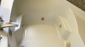 A white bathtub with a chrome faucet and a single drain. - Travelodge by Wyndham Cedar City (Cedar City)