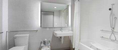 A modern bathroom with a toilet, sink, and bathtub.