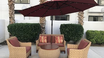 Outdoor pool, open 6 AM to midnight, pool umbrellas, pool loungers