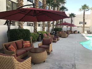 Outdoor pool, open 6 AM to midnight, pool umbrellas, pool loungers