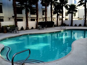 Outdoor pool, open 6 AM to midnight, pool umbrellas, sun loungers