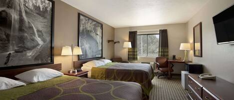 A hotel room with two beds, a desk, a chair, a TV, and a window with curtains.