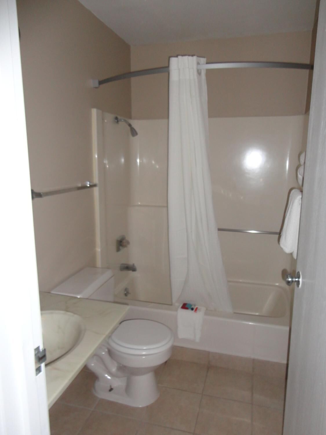 A bathroom with a toilet, sink, and bathtub.