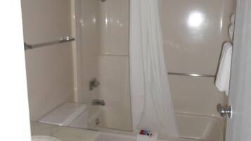 A bathroom with a toilet, sink, and bathtub.