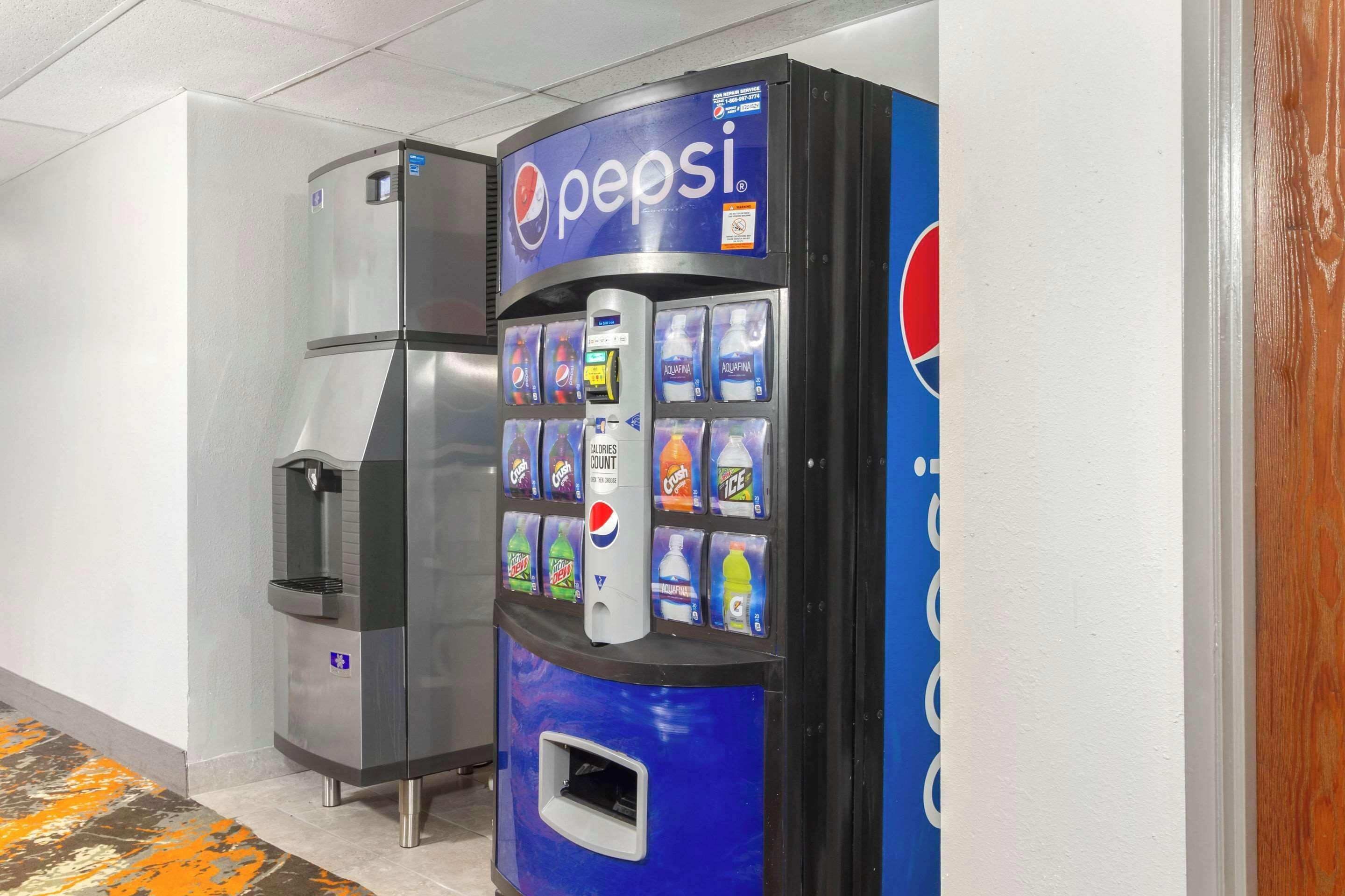 A vending machine with a Pepsi logo and a water dispenser.