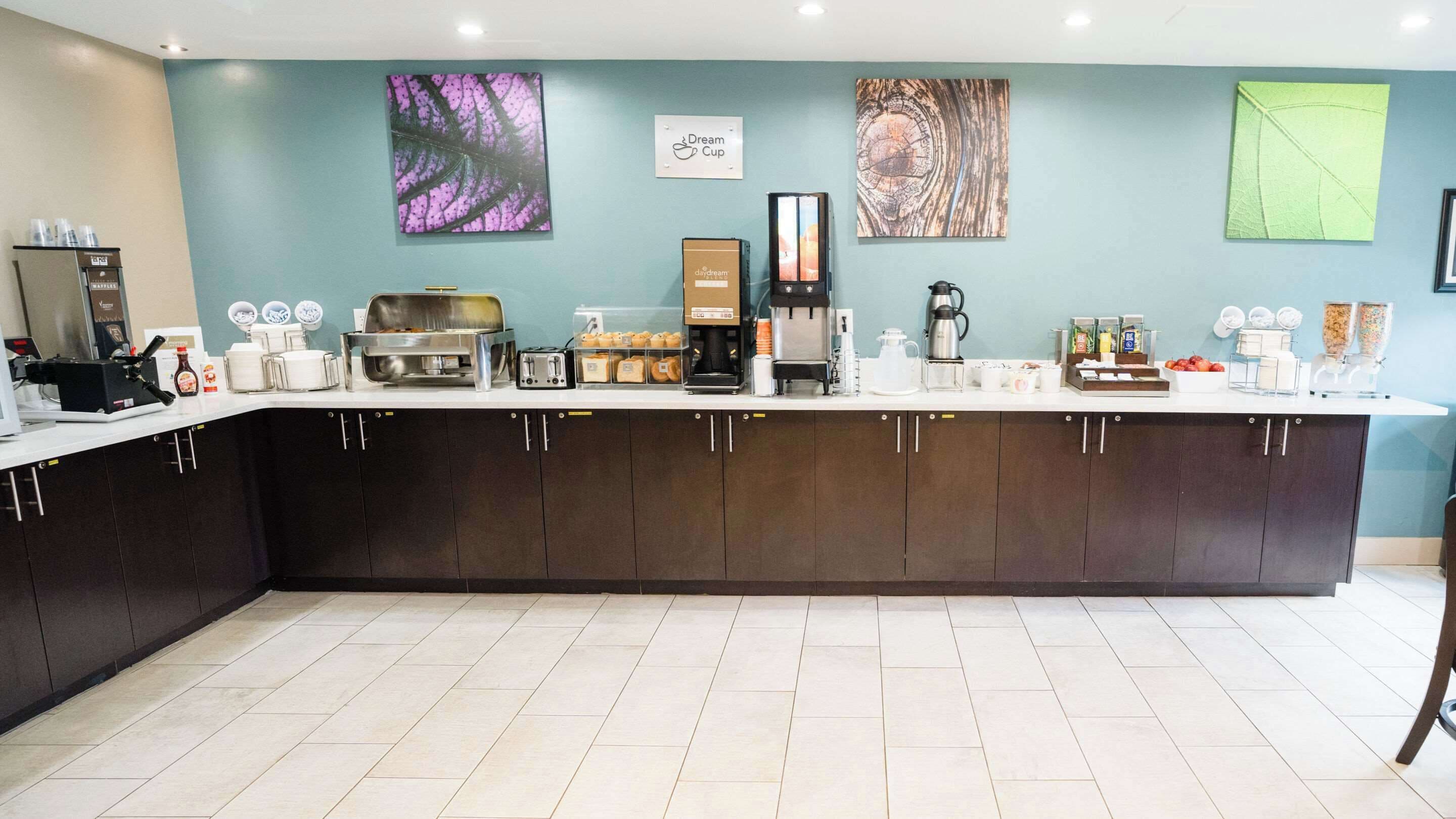 A modern coffee shop counter with various coffee-making equipment, a coffee machine, and a display of coffee beans.