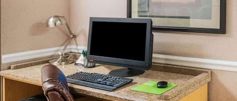 A workspace with a computer, keyboard, mouse, and a printer.