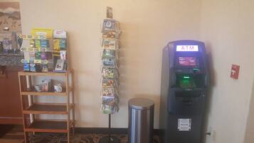A self-service kiosk with a variety of products, an ATM, and a fire alarm.