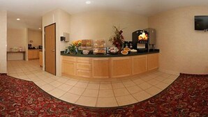 A reception area with a curved counter, a wooden door, and a tiled floor.