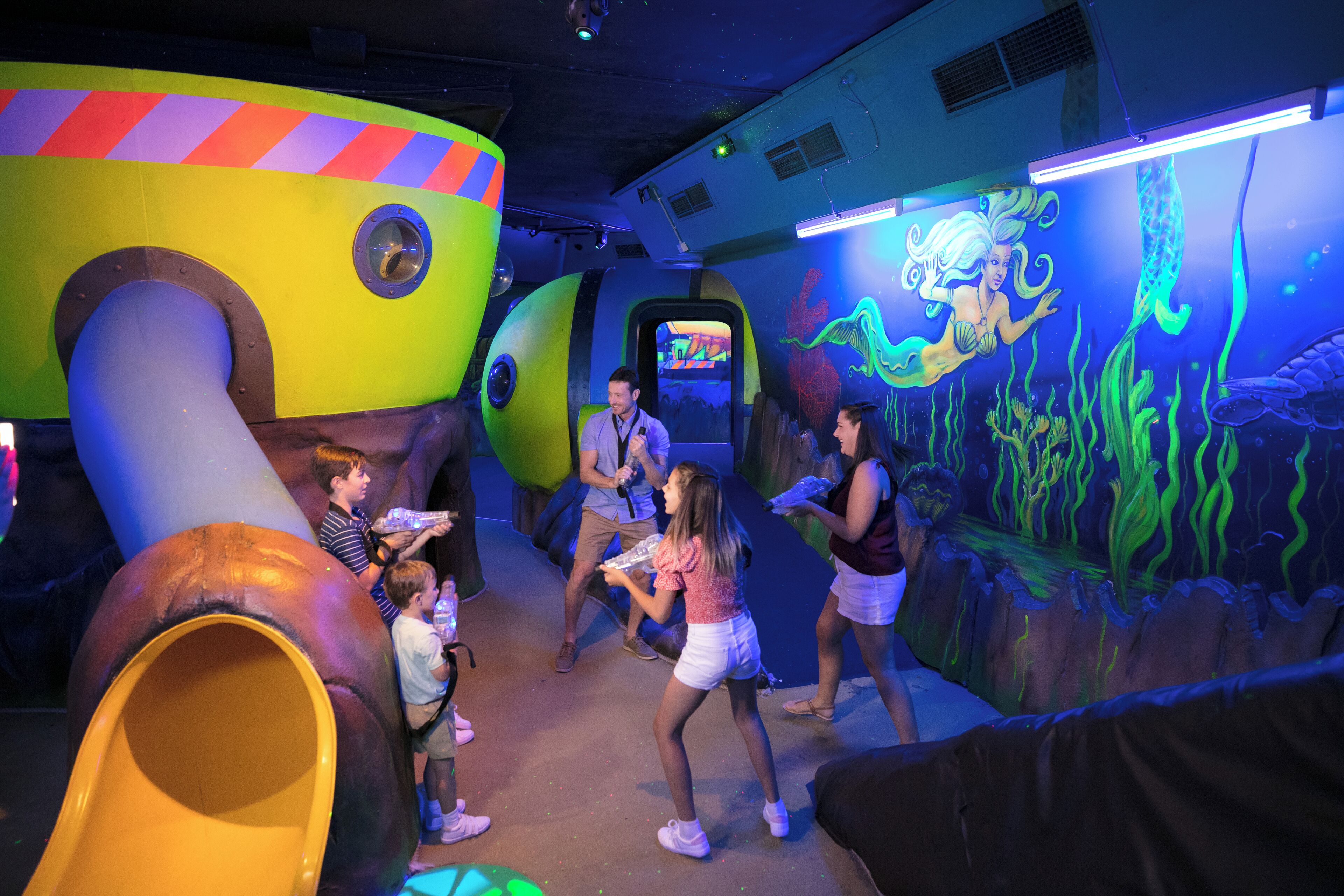 A children's play area with colorful structures and murals.
