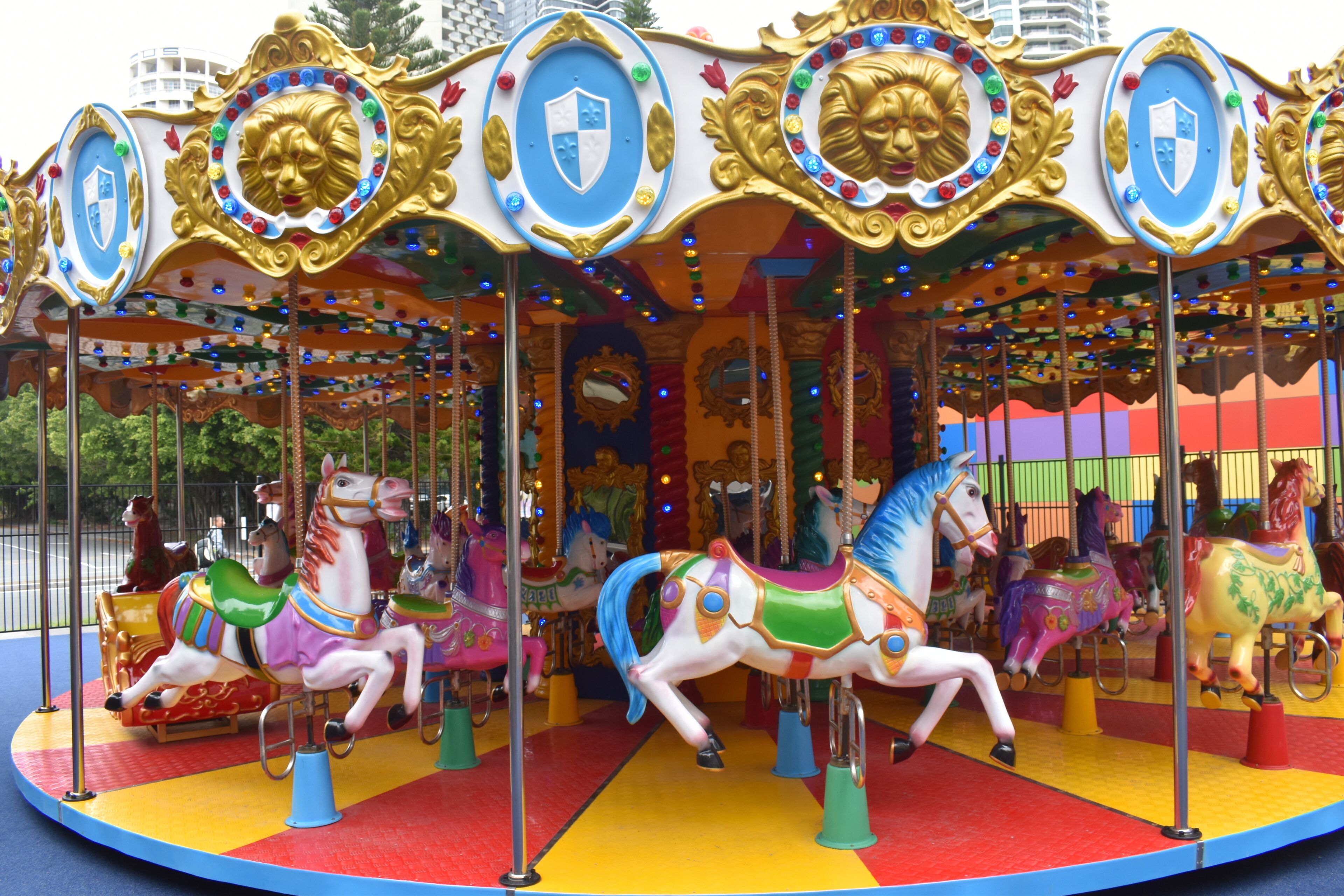 Un carrousel avec des chevaux aux couleurs vives et des décorations dorées élaborées.