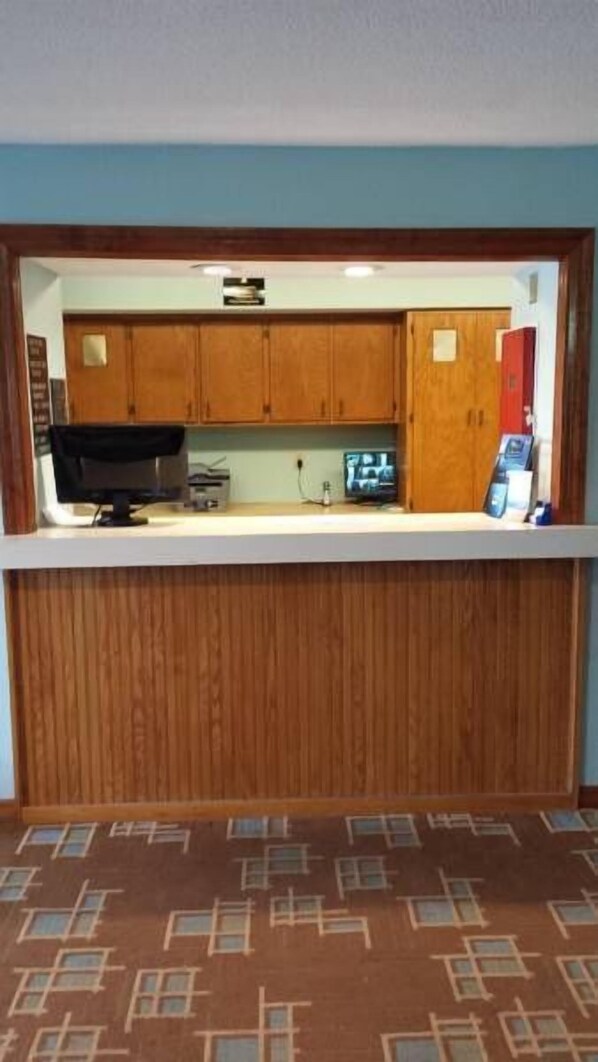 Cozy room with a compact kitchenette featuring a microwave and sink.