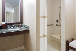 A bathroom with a sink, mirror, shower, and a towel rack. - Pittsburgh Marriott City Center (Pittsburgh)