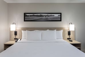 Premium bedding, desk, laptop workspace, blackout drapes