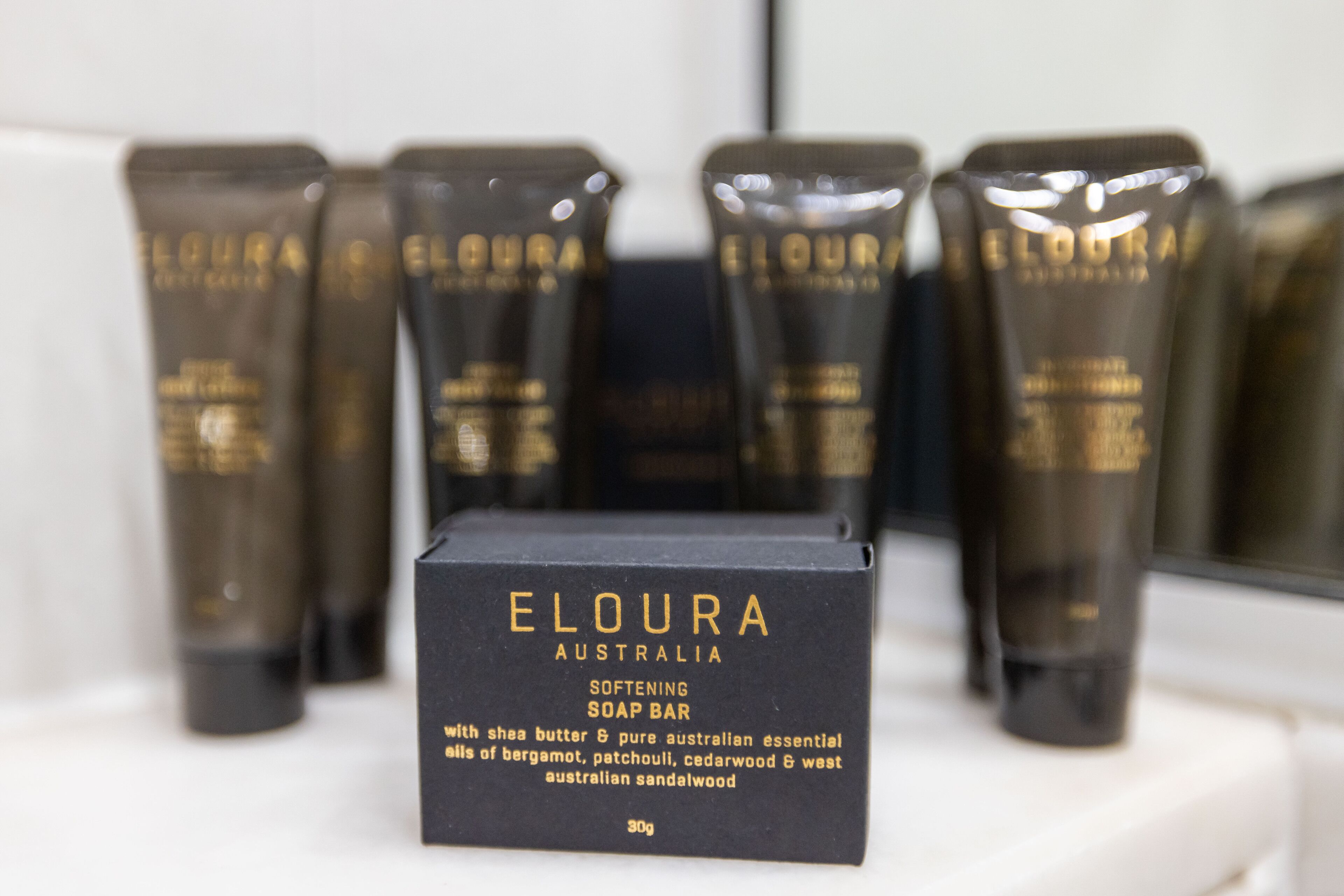 A display of Eloura Australia soap bars with a black box in the foreground.