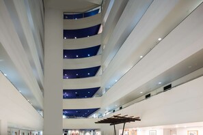 A multi-level atrium with a central open space and balconies. - Rydges Darwin Central (Darwin)