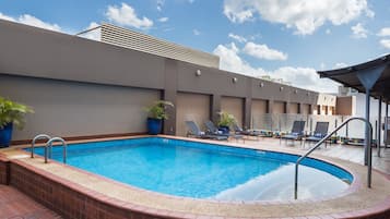 Outdoor pool, open 6:00 AM to 8:00 PM, pool loungers