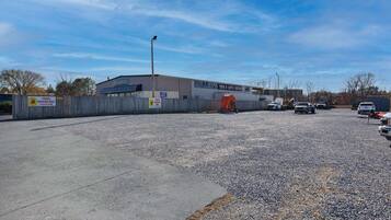 A parking lot with a building labeled "Miller's Tire & Auto Service" in the background.
