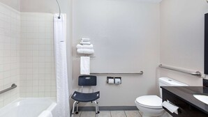 A bathroom with a bathtub, toilet, and a shower area. - Super 8 by Wyndham Johnson City (Johnson City)