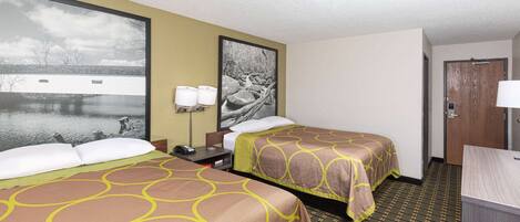 A hotel room with two beds, a desk, a chair, and a large window with a view of a body of water.