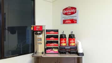 A coffee station with a coffee machine, dispensers, and branded packaging.