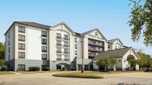 A multi-story hotel with a prominent "Hyatt Place" sign, a central courtyard, and a covered entrance.