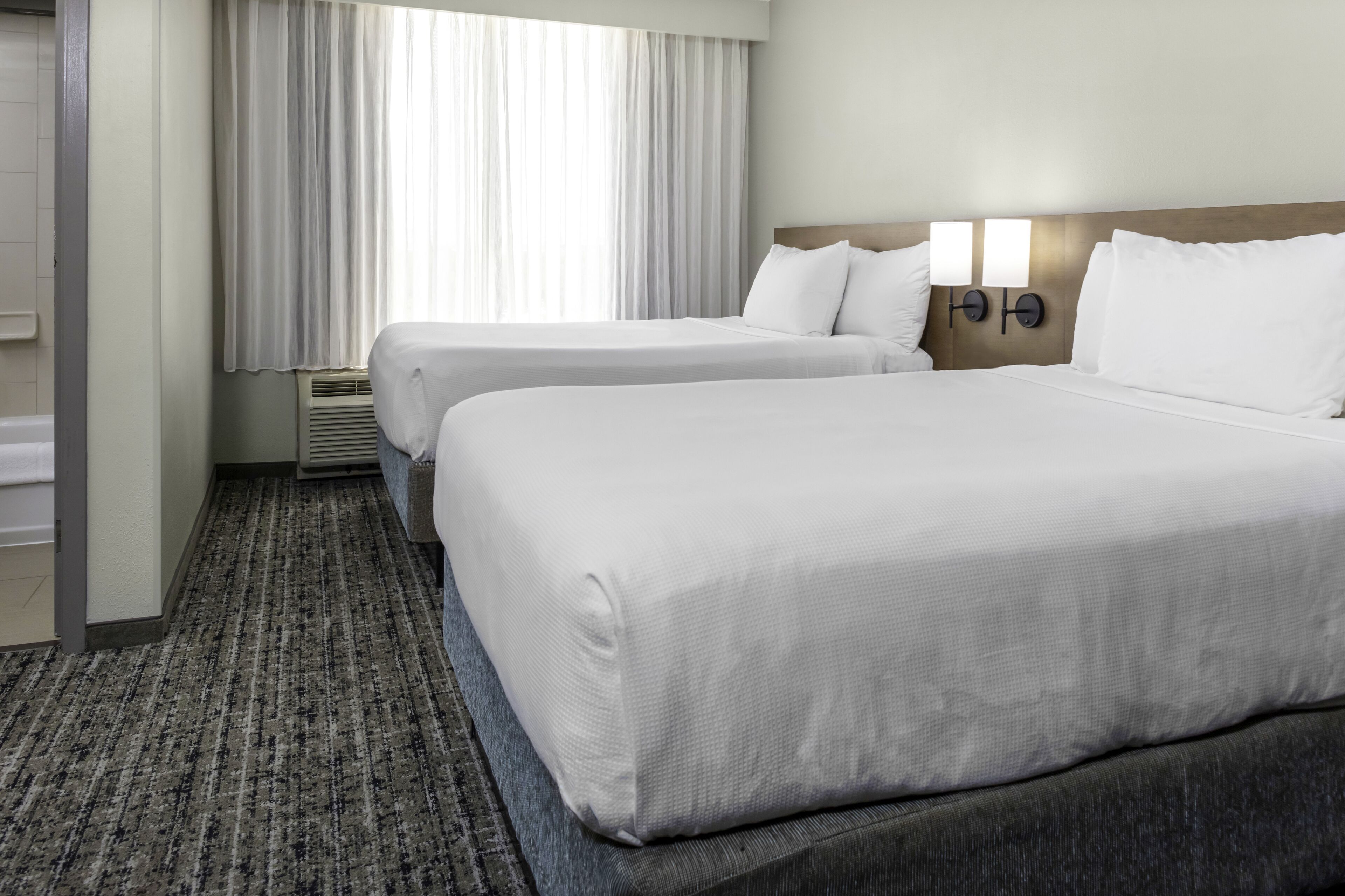 premium bedding, pillow-top beds, desk, blackout curtains