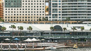 A hotel with a modern design, featuring a large number of windows and a prominent 'ibis HOTEL' sign. - ibis Sydney Darling Harbour (Sydney)
