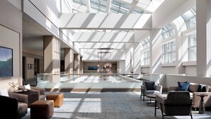 A spacious lobby with a high ceiling, large windows, and modern furniture. - Sheraton Dallas Hotel (Dallas)