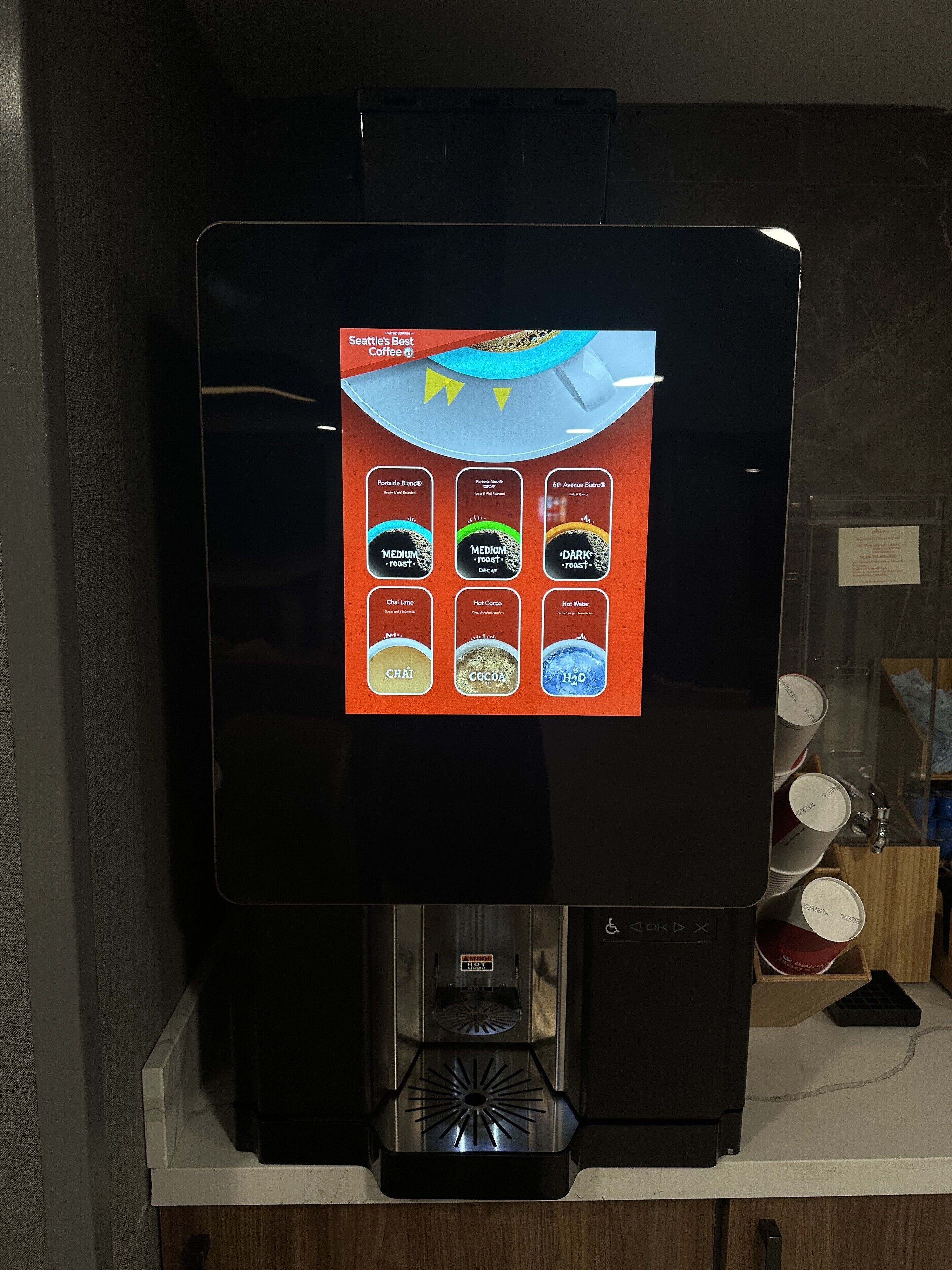 A coffee machine with a digital display menu.