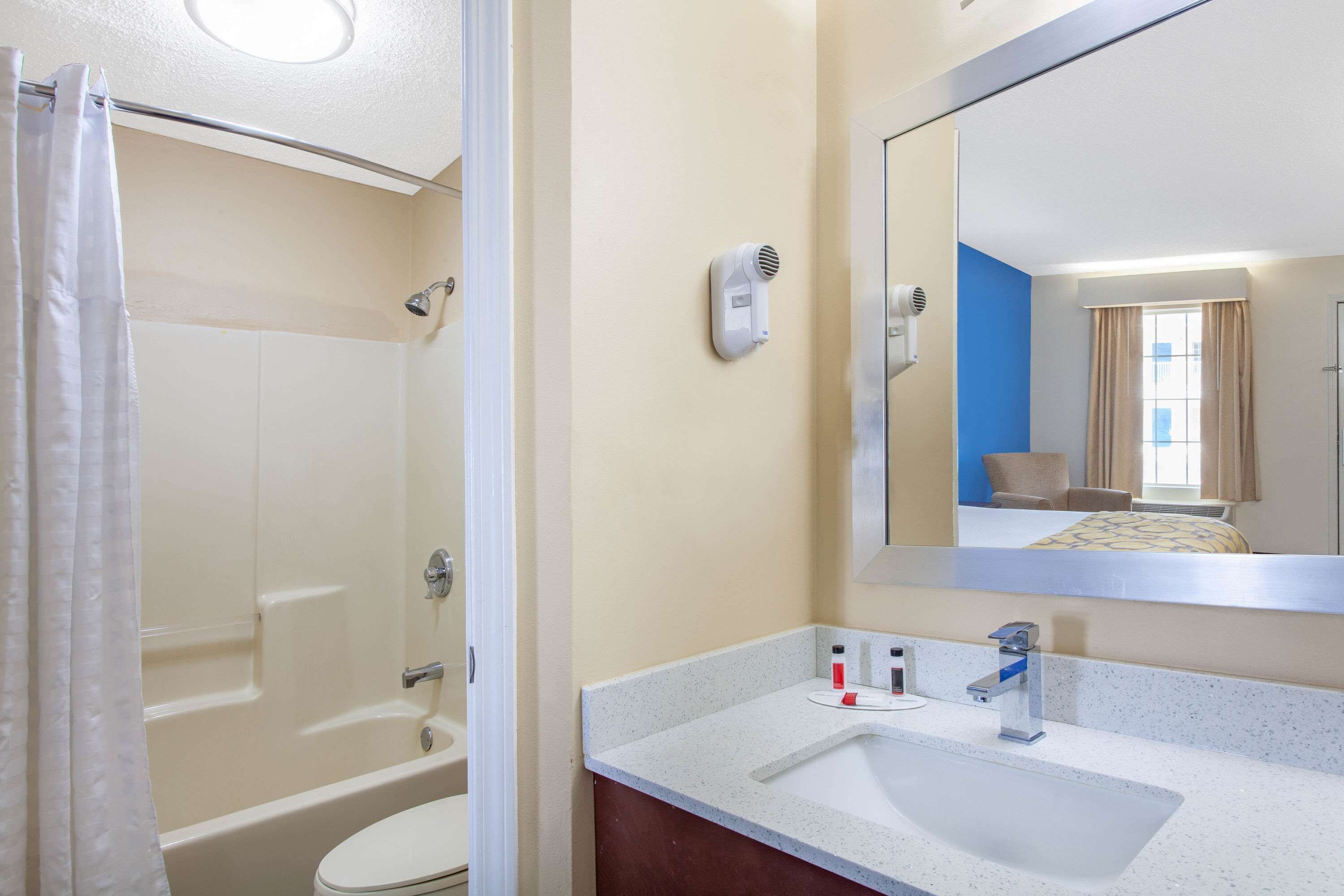 A bathroom with a bathtub, toilet, and sink.