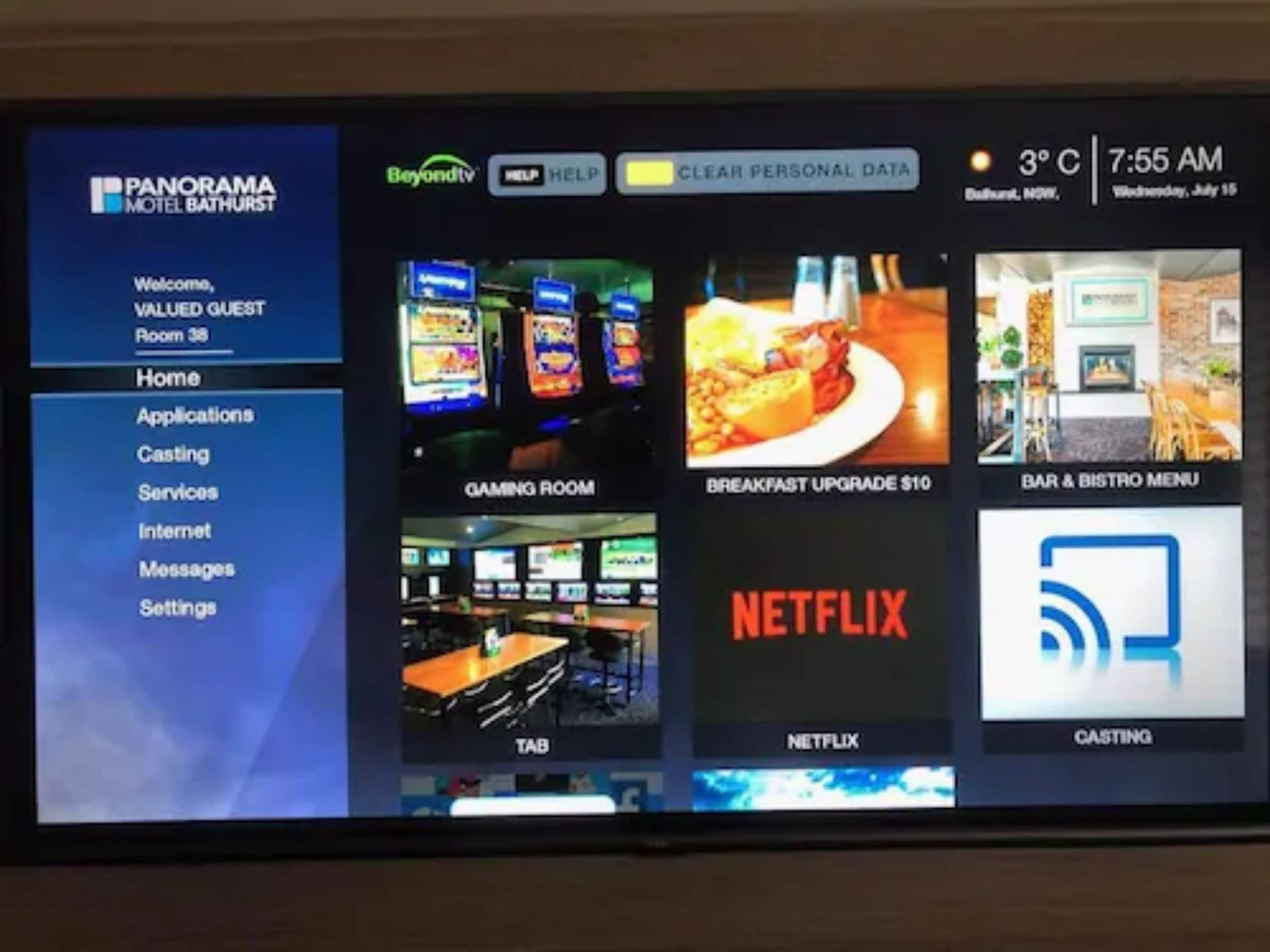 A hotel room's digital interface with options for gaming room, breakfast upgrade, Netflix, and casting services.