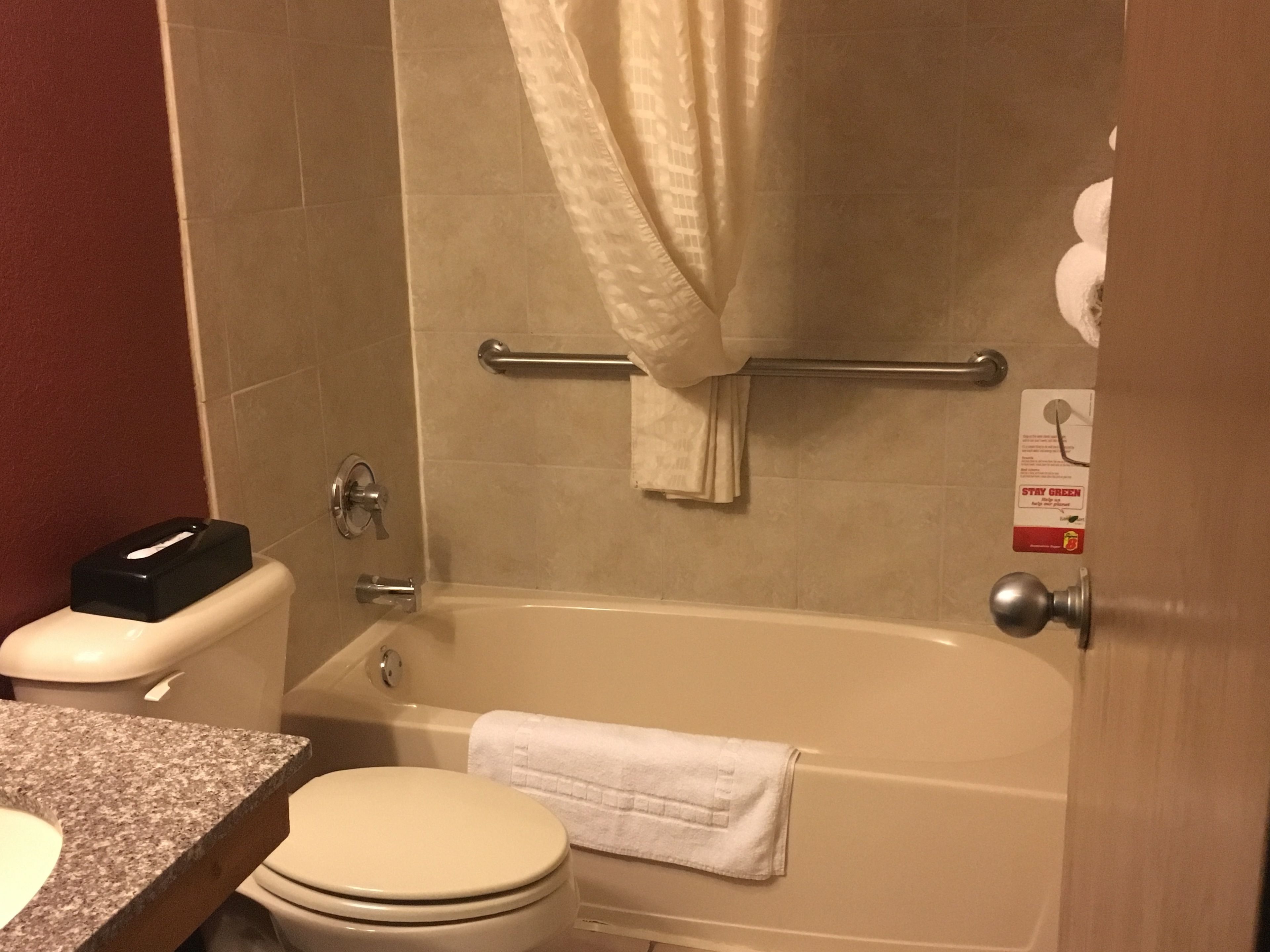 A bathroom with a toilet, sink, and bathtub.