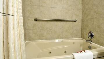A bathroom with a bathtub, a towel rack, and tiled walls.