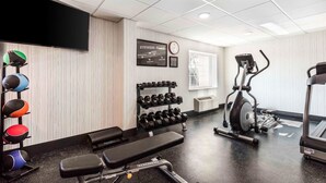 A gym with a bench, dumbbells, an elliptical, and a treadmill. - Comfort Inn Memphis Airport West (Memphis)
