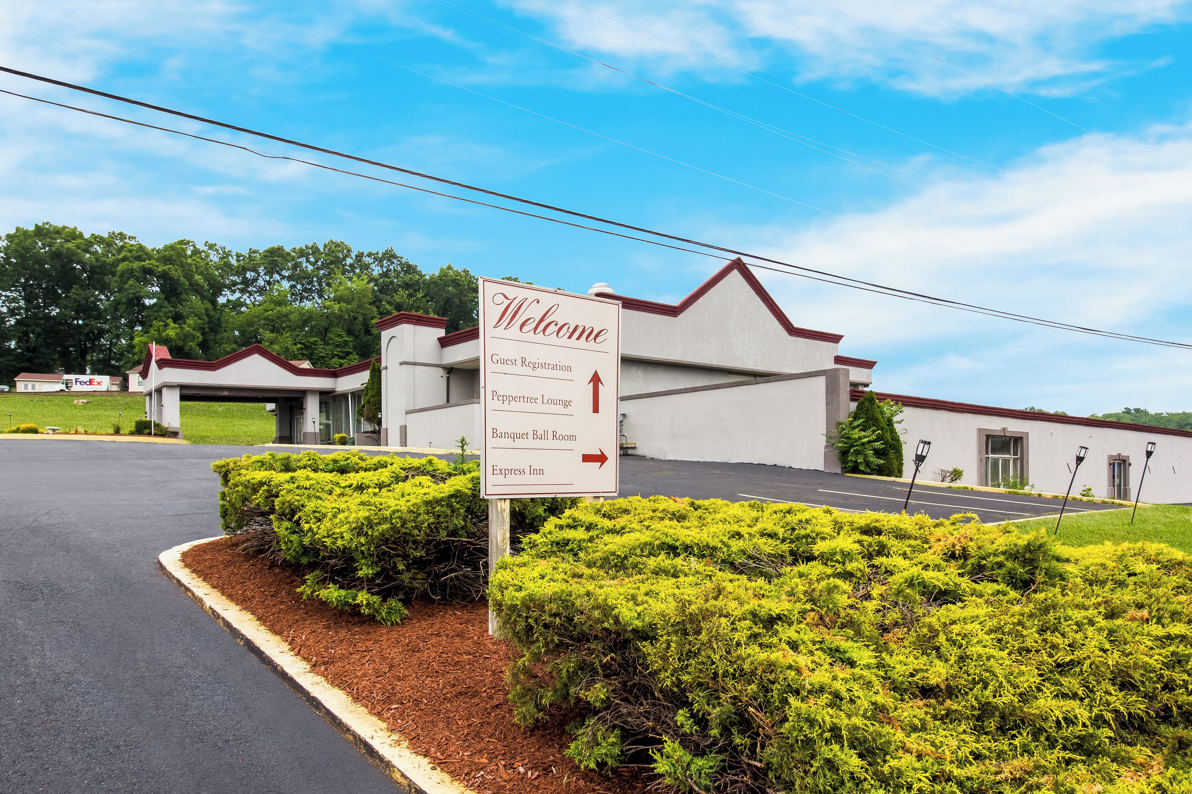 A hotel entrance with a 'Welcome' sign, guest registration, a Peppertree Lounge, a Banquet Ball Room, and an Express Inn.