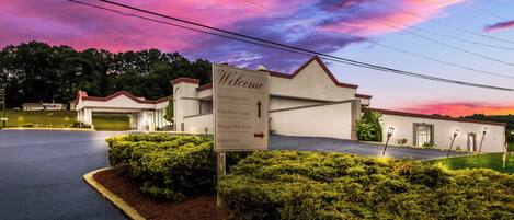 A guest registration sign for a hotel with directions to the Peppertree Lounge, Banquet Ball Room, and Express Inn.
