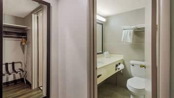 A bathroom with a toilet, sink, and towel rack.