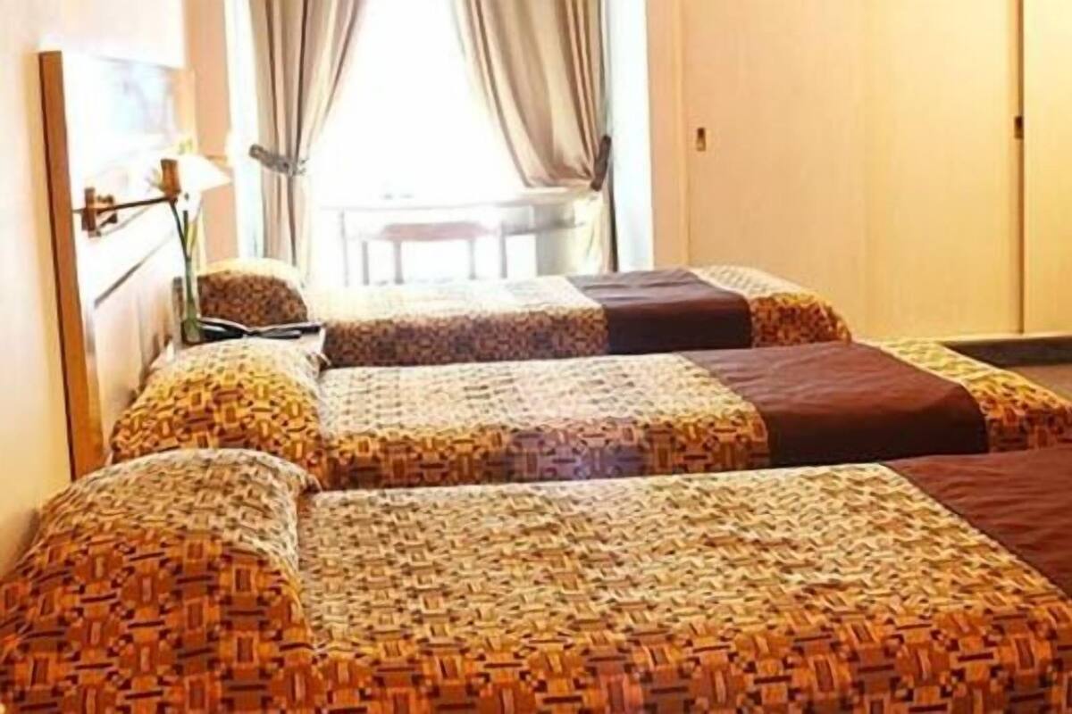 Triple Room | Minibar, in-room safe, desk, blackout drapes