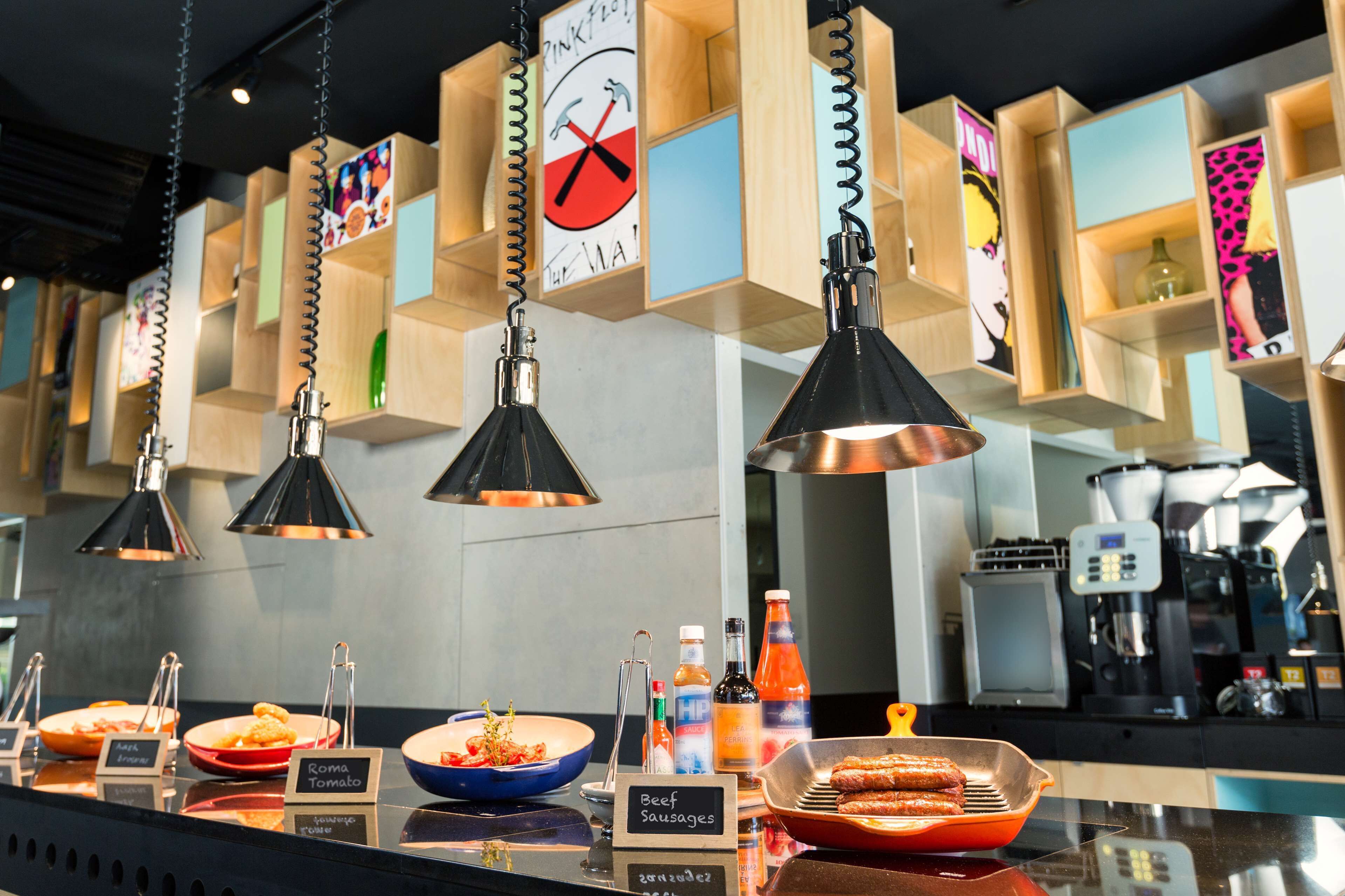 A buffet area with various food options and a coffee machine in the background.