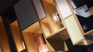 A modern interior with geometric shelving units and a decorative vase.