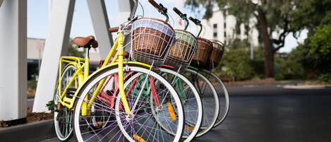 A row of bicycles parked under a white structure.