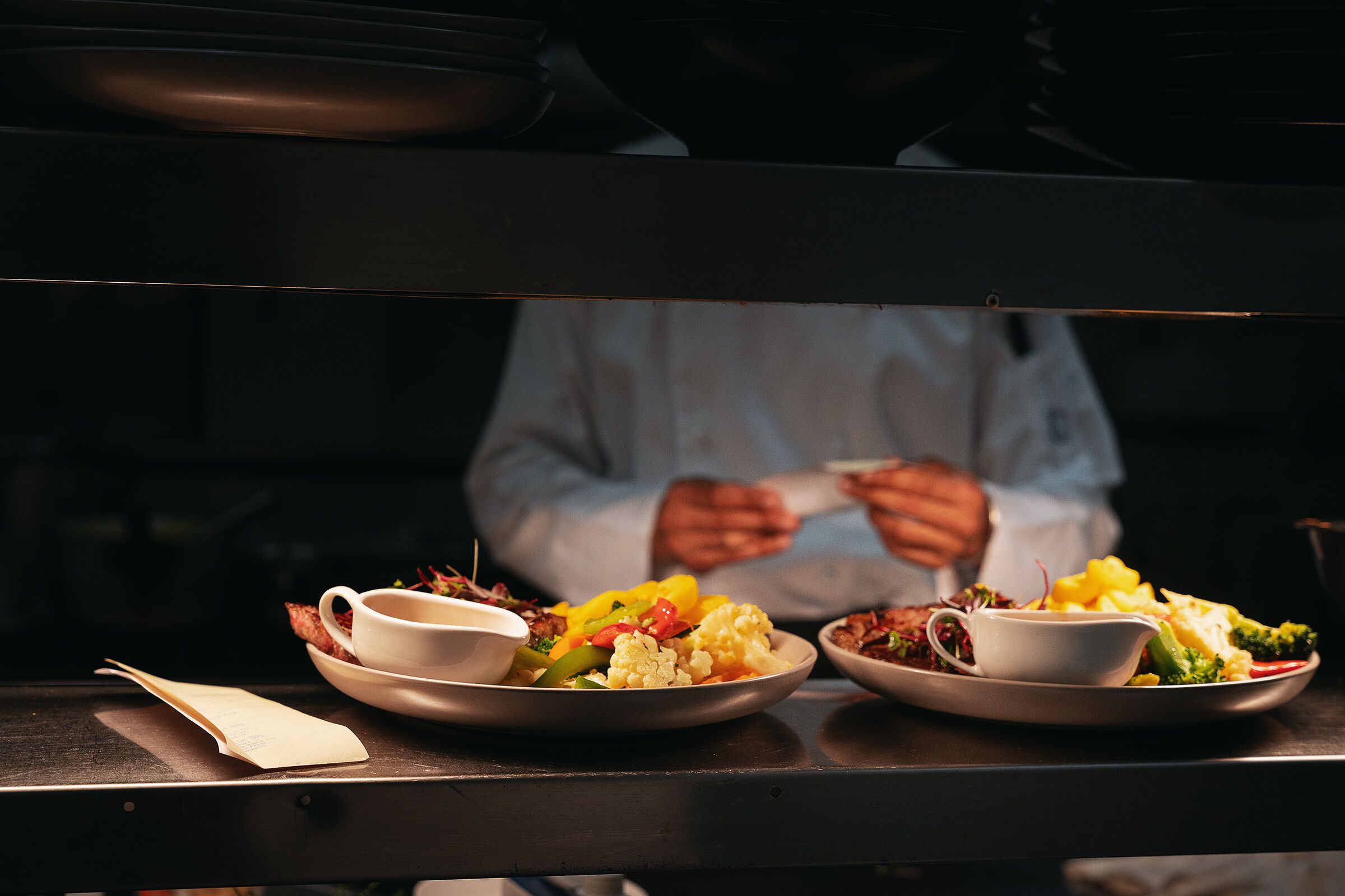 A dining table with plates of food and a menu.