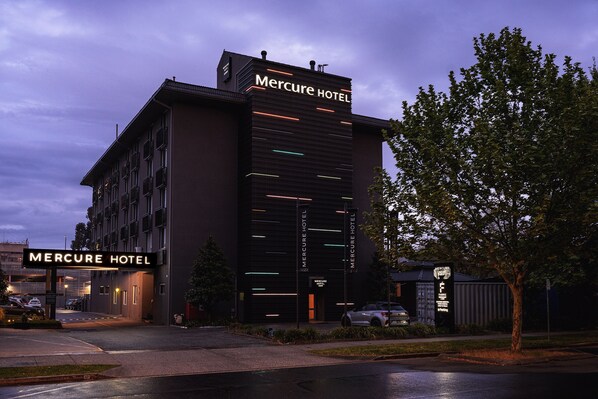 A modern hotel building with the name 'Mercure Hotel' prominently displayed on the facade.