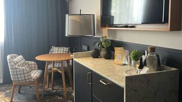 Minibar, desk, laptop workspace, iron/ironing board