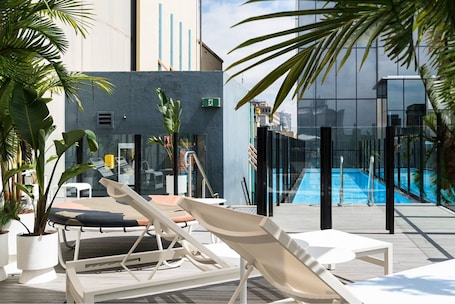 Outdoor pool, open 6:00 AM to 6:00 PM, pool loungers. Adelphi Hotel
