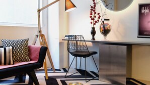 A modern living room with a sofa, a coffee table, a lamp, and a mirror. - Adelphi Hotel (Melbourne)
